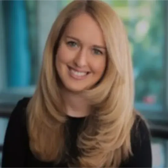 Maureen Slattery profile shows her with long blonde hair and indoors.